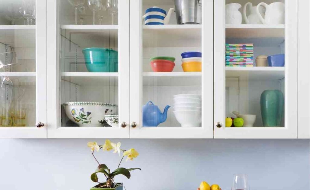 cabinet shelves with colorful crockery to elevate kitchen decor aesthetics