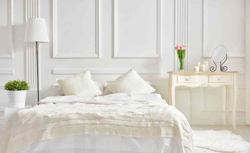 completely white bedroom decor with classical wall panels